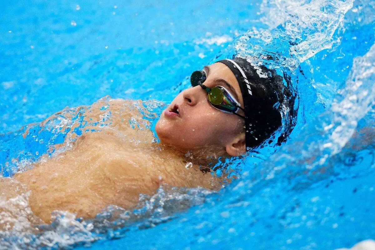 Private training lessons - photo shows a swimmer swimming backstroke